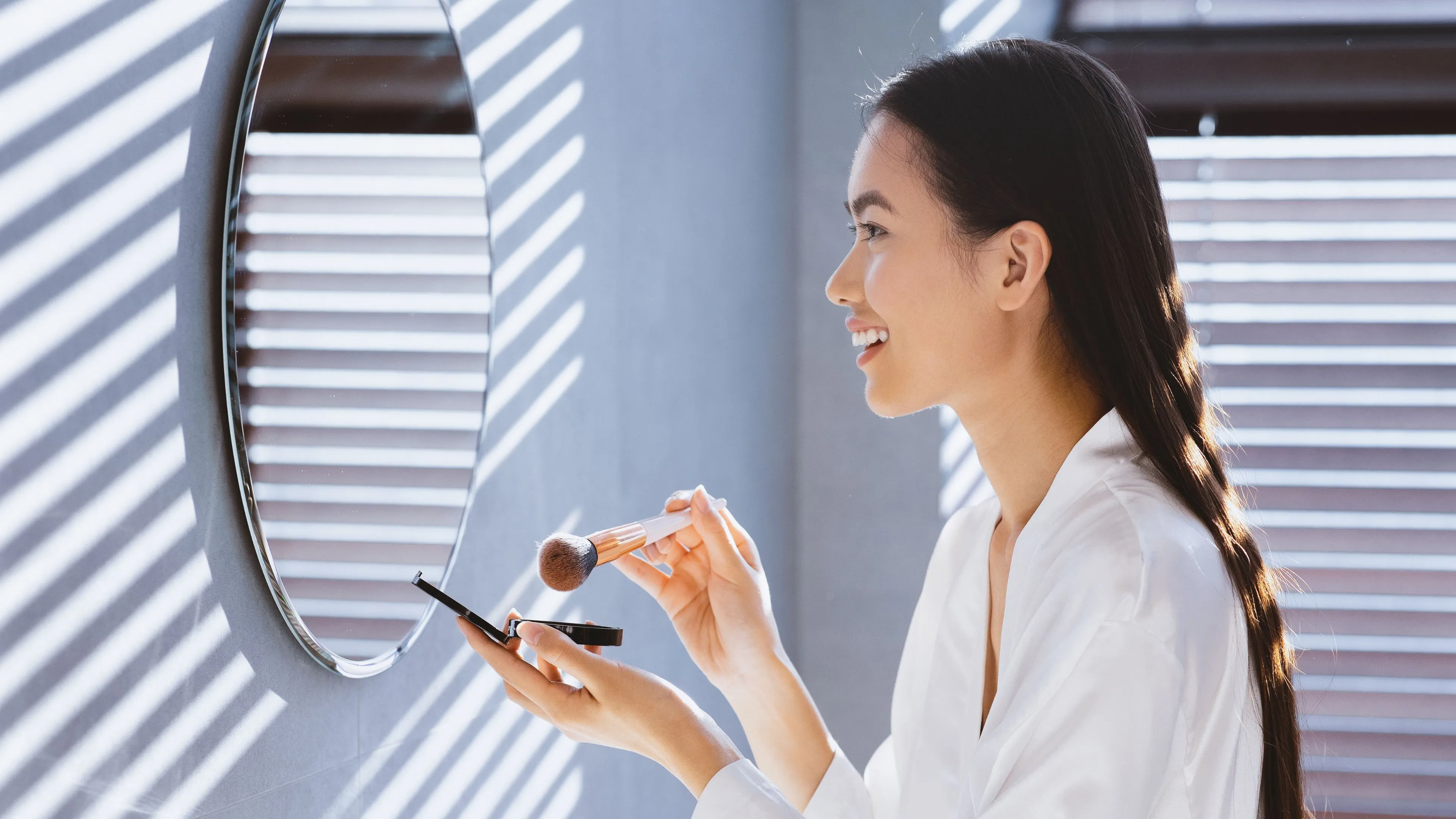 Experienced glazier holding a large clear glass panel for a custom mirror cutting and installation project in Dallas.